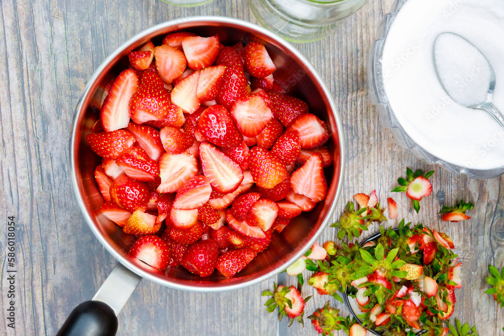 Wall mural making jam starts with cleaning and cutting fresh red strawberries