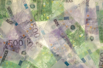 Blurred photo of one hundred and five hundred euros are defrosted in ice. The European cash currency is frozen.
