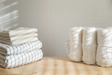 Bath fresh towels pile soft textile cotton body care neatly folded white gray laundry flower shelf - obrazy, fototapety, plakaty