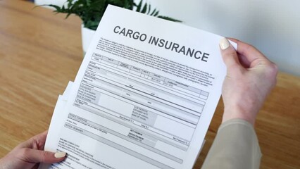 A woman opening a cargo insurance policy letter document.