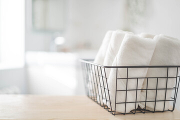 Spa white towel rolled in metallic basket comfortable hygiene fresh textile bathroom. Blurred background