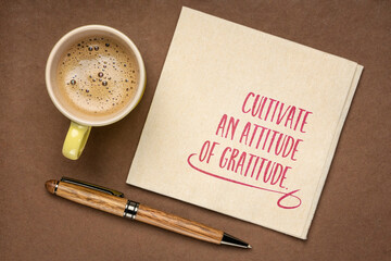 cultivate an attitude of  gratitude - inspirational handwriting on a napkin with a cup of coffee,...