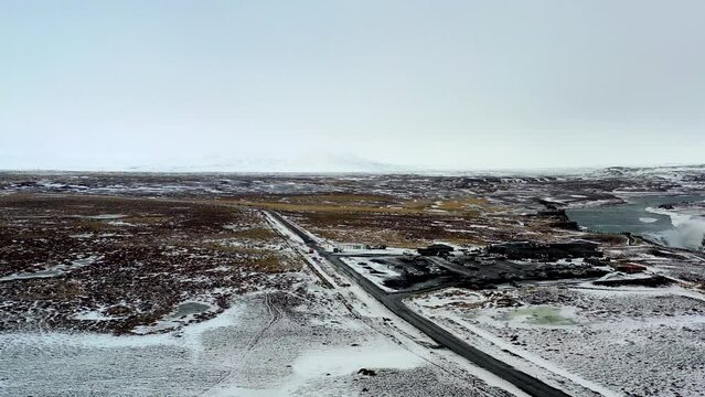 Aerial view of an icelandic winter road with the famous Gullfoss Waterfall in the background.
