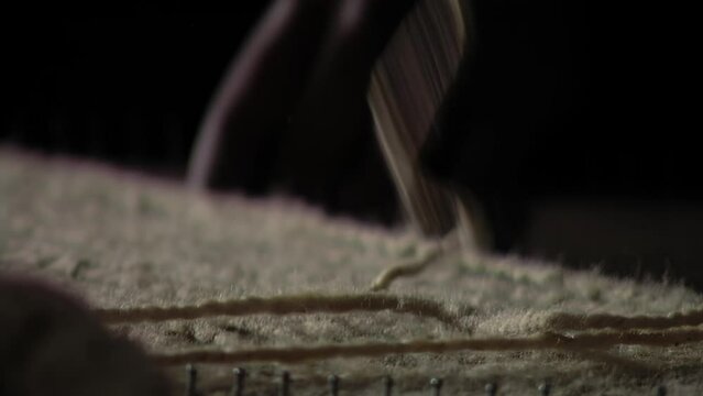 Hands of a Young Woman Weaving Traditional Fabric Using a Hand Loom in Catamarca, Argentina. Closeup. 