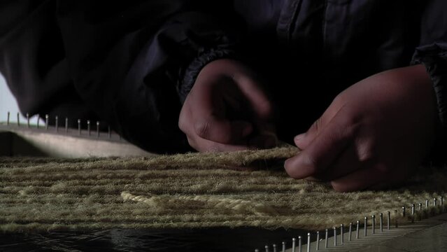 Hands of Young Woman Weaving Traditional Fabric on Hand Loom, Catamarca, Argentina - Close Up
