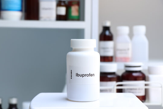 Ibuprofen pill in white bottle, pill stock