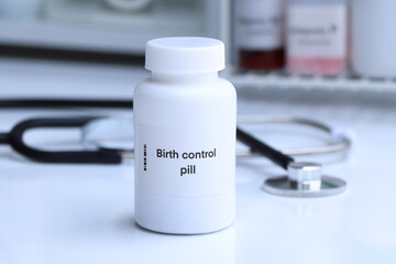 Birth control pill in white bottle, pill stock