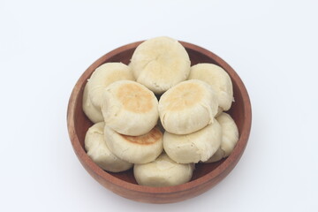a close up of Bakpia served in a wooden bowl