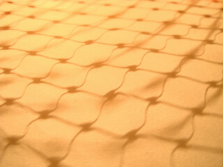 golden background
Shadows of points that  connect orange color light  and lines on white construction paper