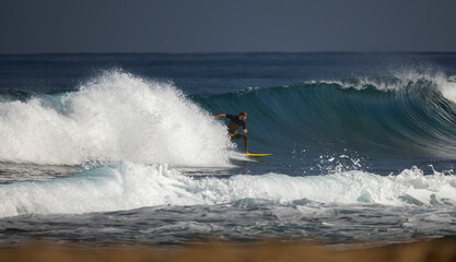Professional surfer on an ocean wave.