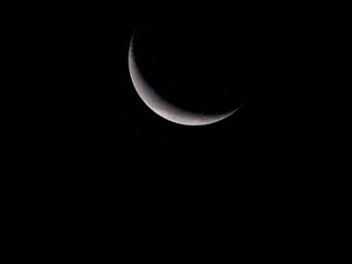 Obraz na płótnie Canvas Partial Solar Eclipse of the Moon in a Cloudy Night