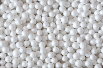 Styrofoam balls texture, background top view, macro.
