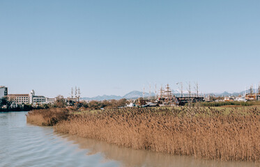 Ship graveyard in Turkey on river with dry grass on the sides