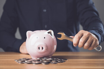 Financial problem fixing, Money repair or maintenance idea. Broken pink piggy bank and wrench,...
