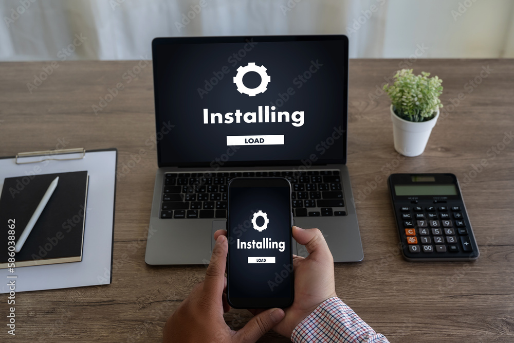 Aufkleber man installing software update on mobile phone and laptop digital technology communication