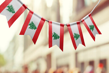 A garland of Lebanon national flags on an abstract blurred background