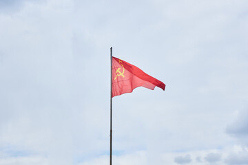 The flag of the USSR is fluttering in the wind. The Soviet period of the history of Russia.