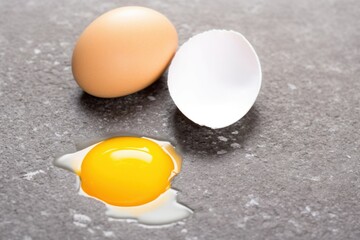 egg, broken egg with raw yolk close-up on the floor