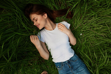 woman dreaming lying on the grass 