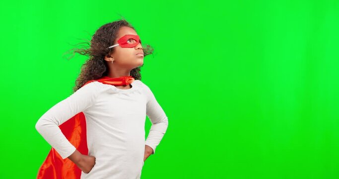 Superhero, costume and child in a studio with green screen with mockup space for advertising. Mask, young and girl kid with wind blowing her cosplay outfit to stop crime by a chroma key background.