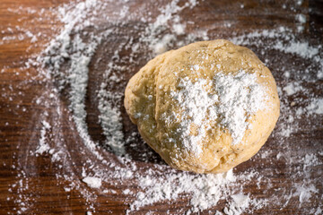 Bakery - yeast dough for bread, pizza or scone on a floured surface, with flour splash. Cooking bread on wooden board. Long banner format