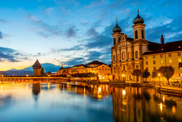 Night view of Kapellbruecke with Francis Xavier church at Swiss town Luzern
