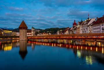 Night view of Kapellbruecke with Francis Xavier church at Swiss town Luzern