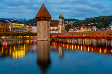 Night view of Kapellbruecke with Francis Xavier church at Swiss town Luzern