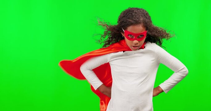 Portrait, superhero and children with a girl on a green screen background in studio standing hands on hips. Kids, justice and costume with a female child hero playing fantasy as a crime fighter