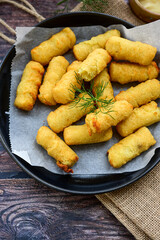  Traditional fried  Potato Croquettes with Cheese  dipping sauce on wooden board