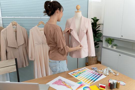 young designer woman standing and organizing her design shirt to develop