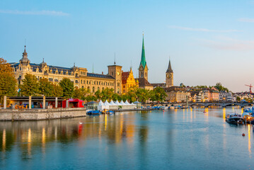 Sunrise view of historic Zuerich city center with famous Fraumuenster Church and river Limmat,...