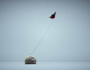 Butterfly tied to a rock flying away. Confidence and mindset concept.