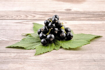 Black currant on wooden background. - 586054801