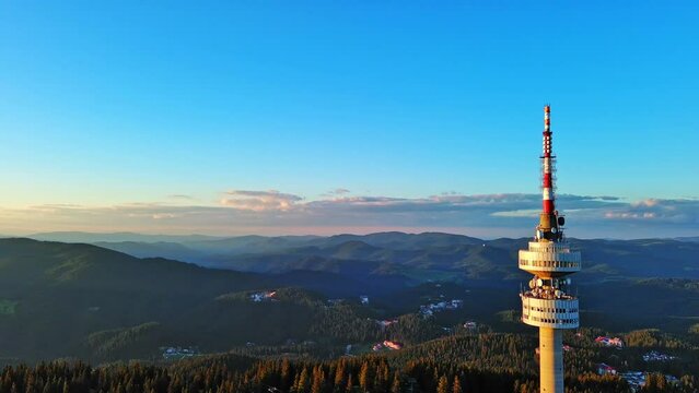 Tower Snezhana on peak of Snezhana covered with spruce forests in Rhodope mountains