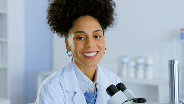 Woman, face and smile in forensic science with microscope for discovery or breakthrough at laboratory. Portrait of happy female scientist smiling for healthcare or scientific research in biology lab