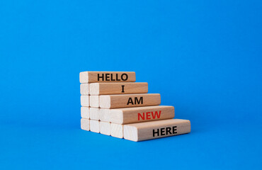 Hello I am a new hire symbol. Concept words Hello I am a new hire on wooden blocks. Beautiful blue background. Business and Hello I am a new hire concept. Copy space.