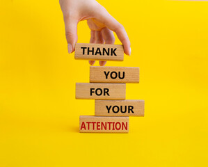 Attention symbol. Wooden blocks with words Thank you for your attention. Beautiful yellow background. Businessman hand. Business and Thank you for your attention concept. Copy space.