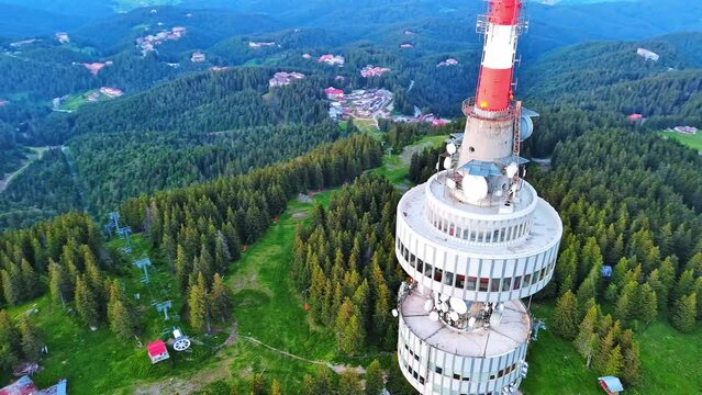 Tower Snezhana on peak of Snezhana covered with spruce forests in Rhodope mountains