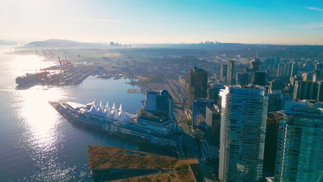 Aerial flythrough downtown Vancouver Harbour skyline, BC, Canada at sunrise
