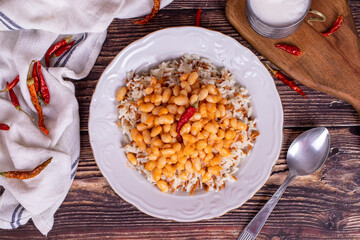 Dry bean pilaf. Traditional Turkish cuisine. Turkish dry beans and rice with ayran and hot pepper. local name kuru fasülye pilav. Top view