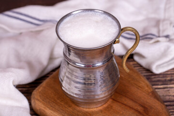 Buttermilk. Sparkling buttermilk in an iron glass. Beverage prepared with yogurt and water. Traditional Turkish delicacies. local name ayran