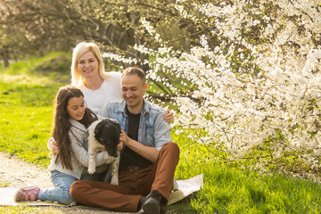 Happy family with dog in the garden.