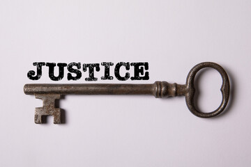 JUSTICE Concept. Text and old key on white background