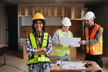 Architect caucasian man and woman working with colleagues mixed race in the construction site....