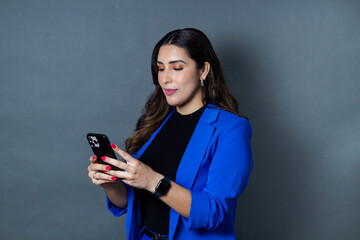 young businesswoman using smart phone. pretty latin woman smiling looking at phone apps