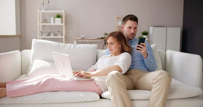Family Couple Using Laptop And Phone
