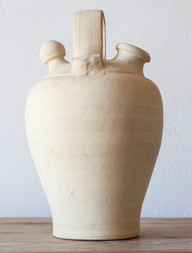 White earthenware botijo, traditional clay pot jug