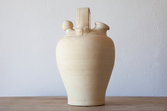 White earthenware botijo, traditional clay pot jug