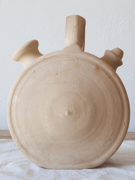 White earthenware botijo, traditional clay pot jug